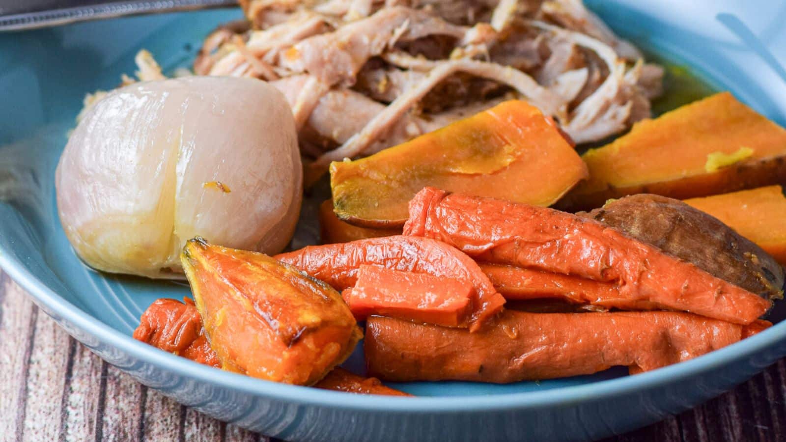 Vegetables on a blue plate with pulled pork