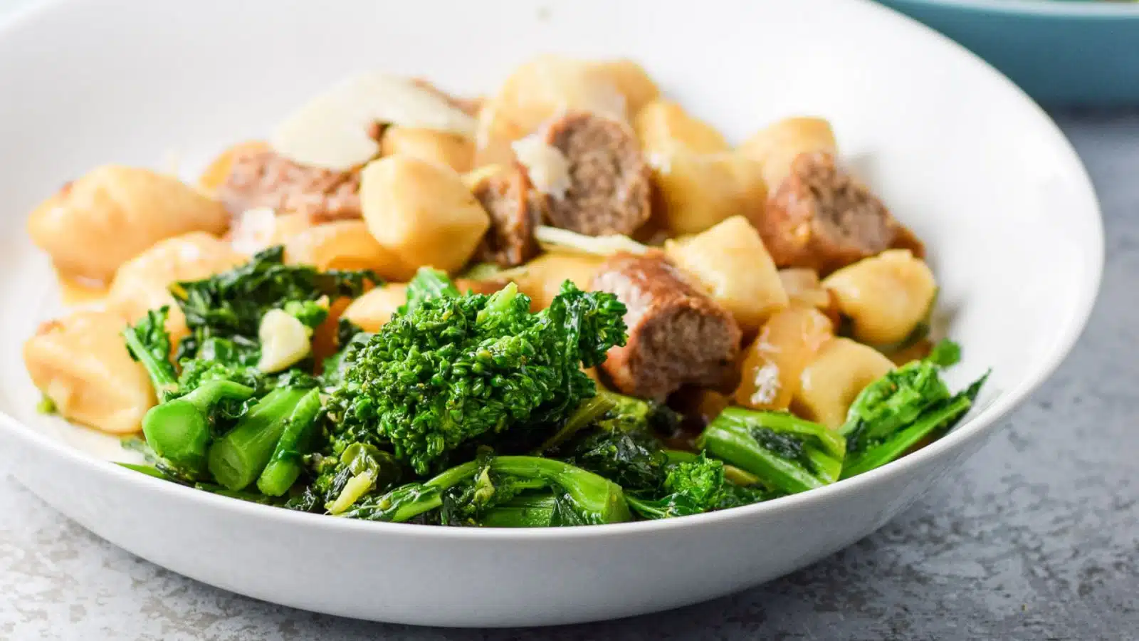 a deep plate with the broccoli rabe with gnocchi and sausage