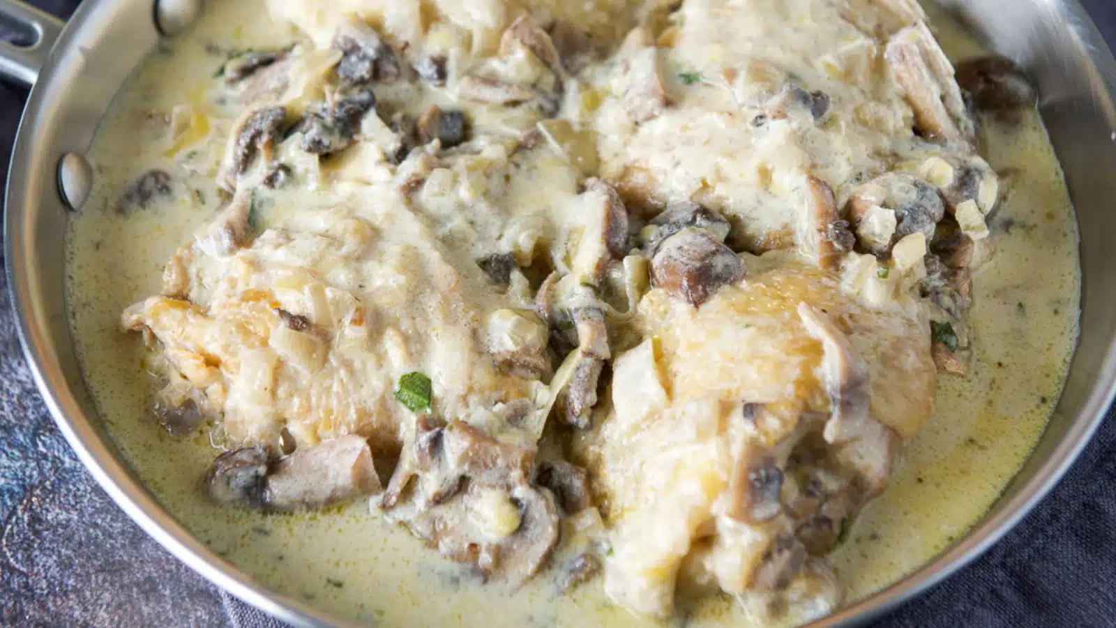 A pan of chicken thighs in a cream sauce
