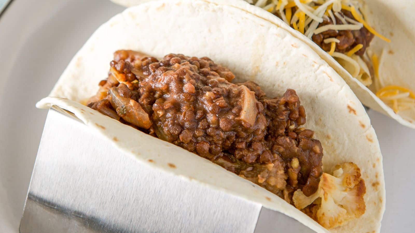 A tortilla filled with vegetables and lentils