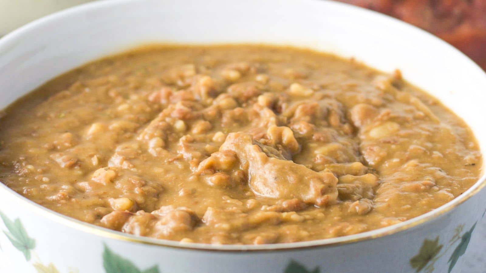 a flowered bowl filled with refried beans