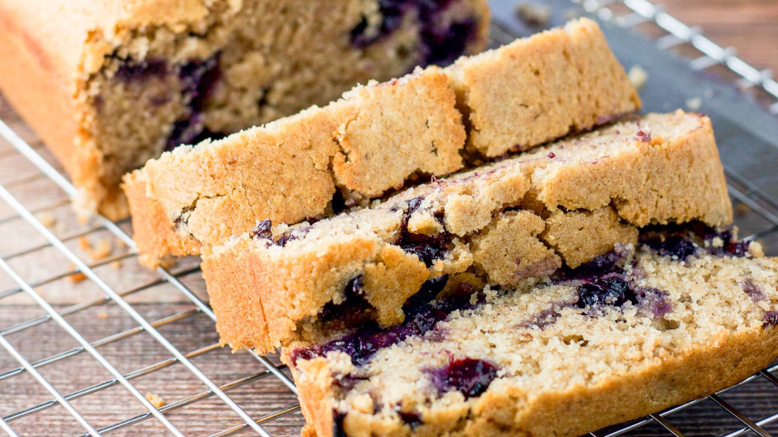 slices of lemon bread on a wire rack with the bread behind it