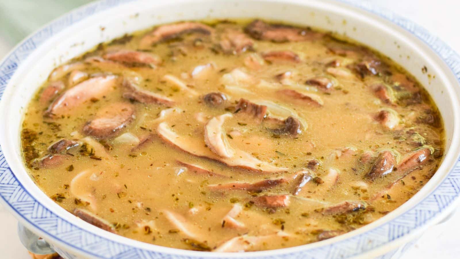 A blue bowl with a mushroom soup in it