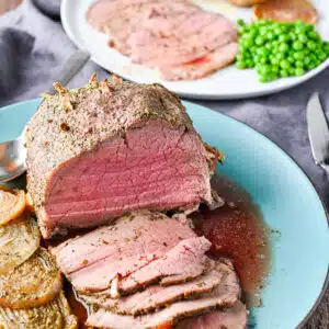 A blue plate with roast beef and slices on it - square
