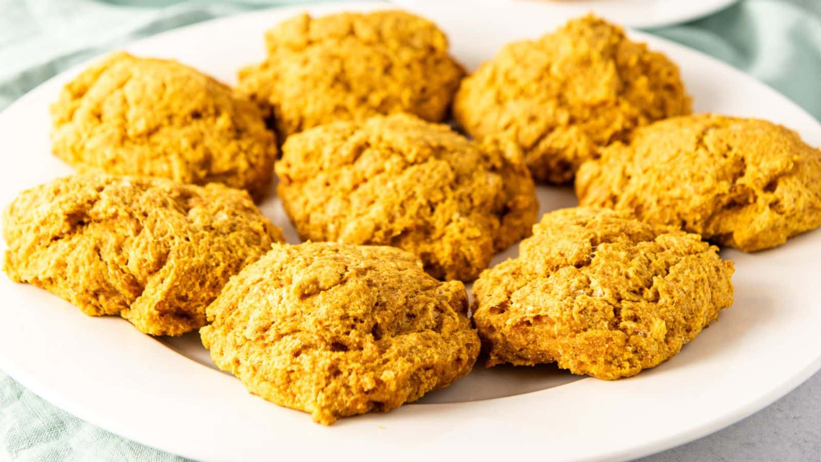 A white plate with eight biscuits on it