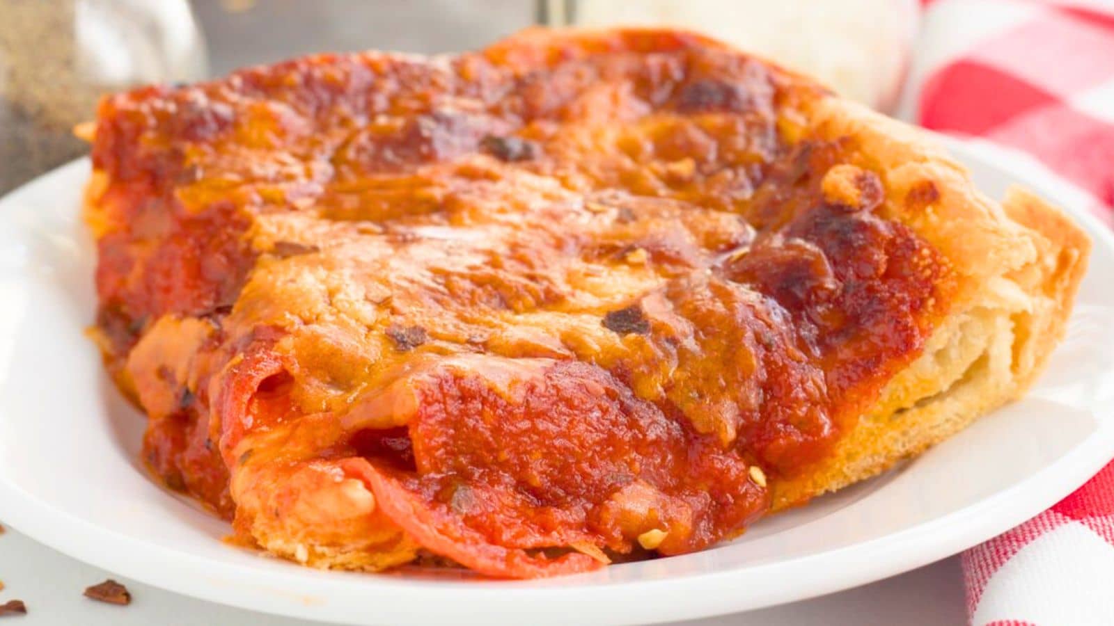 a white plate with the deep dish pizza on it