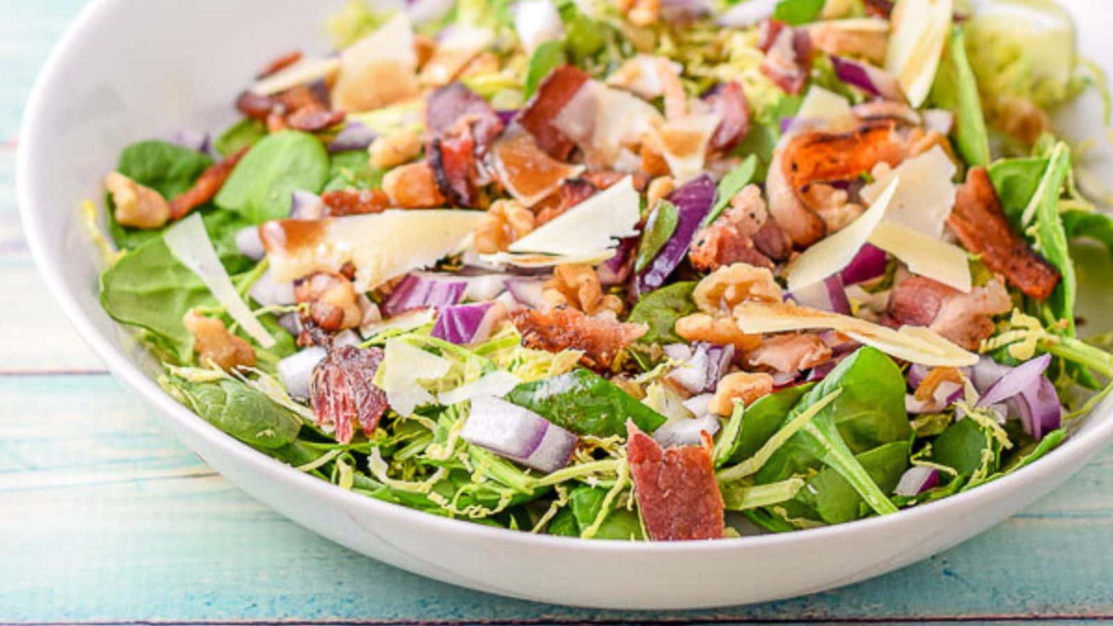 bacon, cheese, bacon, and walnuts on a brussel sprout salad
