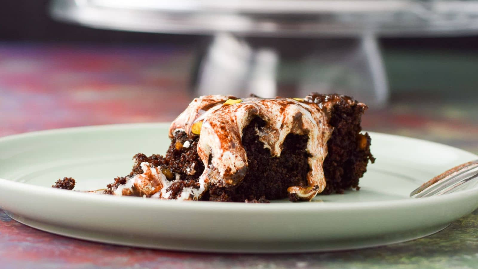 A green plate with the chocolate marshmallow cake on it