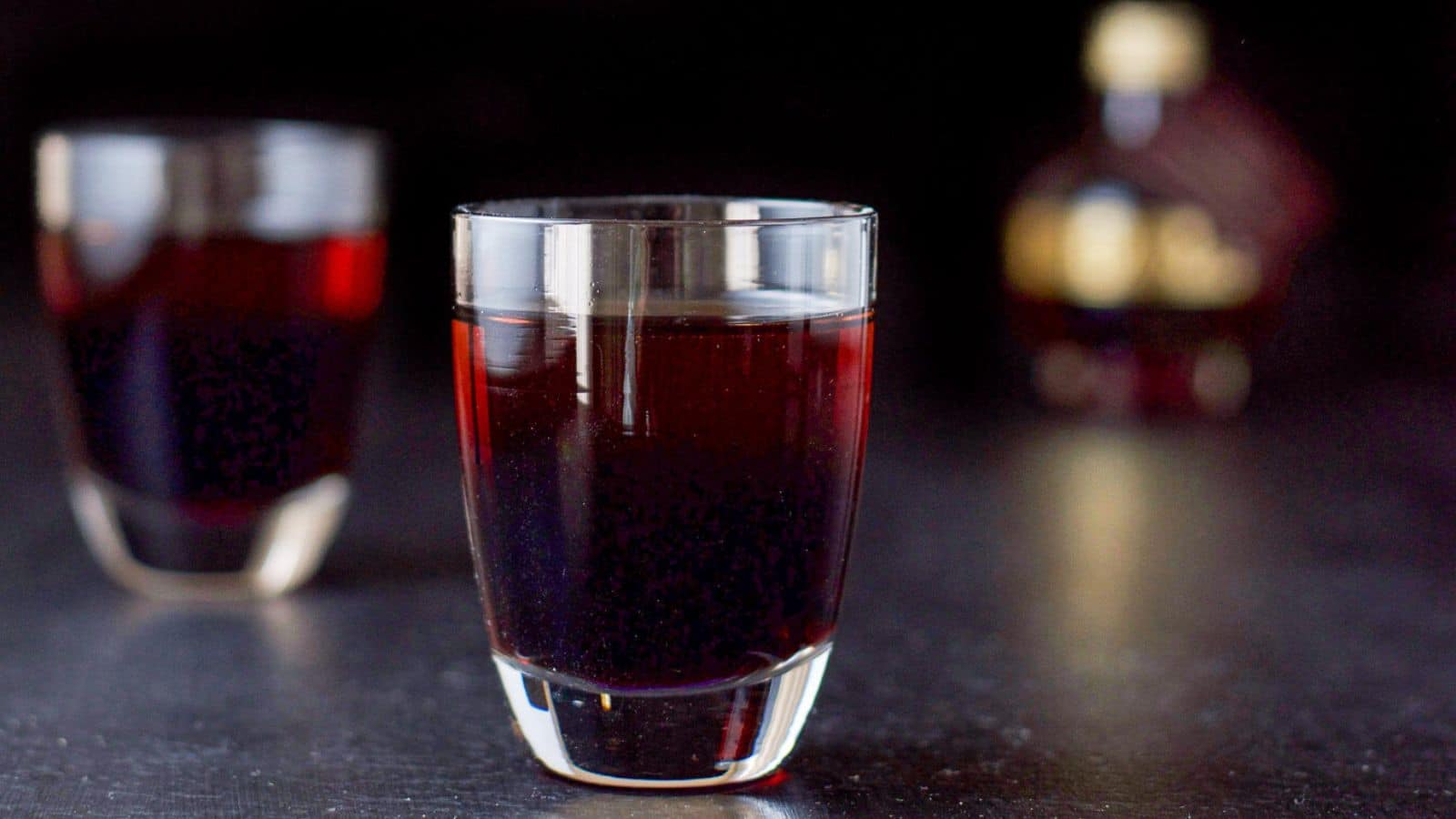 two short glasses with the layered liqueurs in it