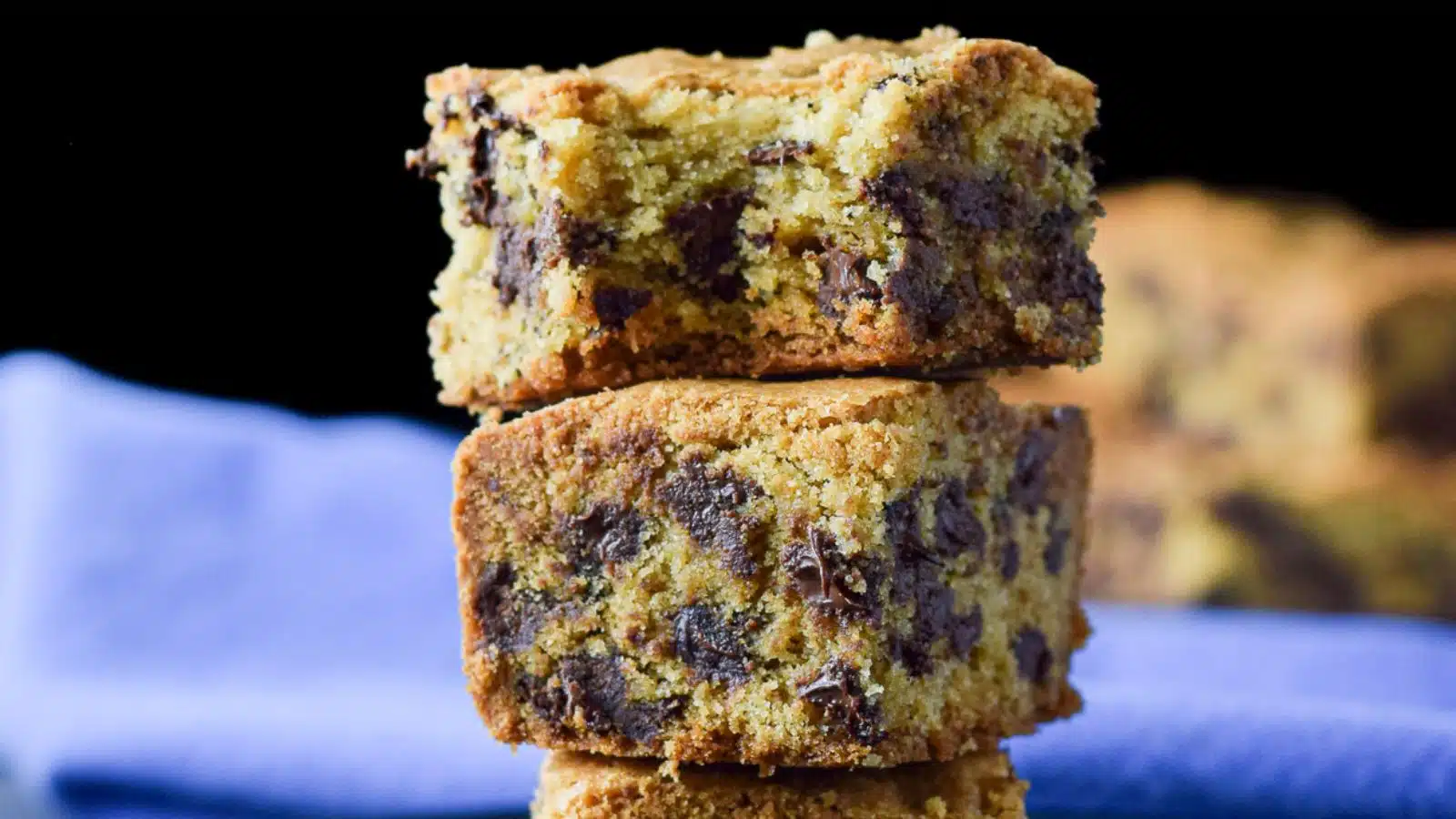 chocolate chip squares piled on each other, one with a bite taken out of it
