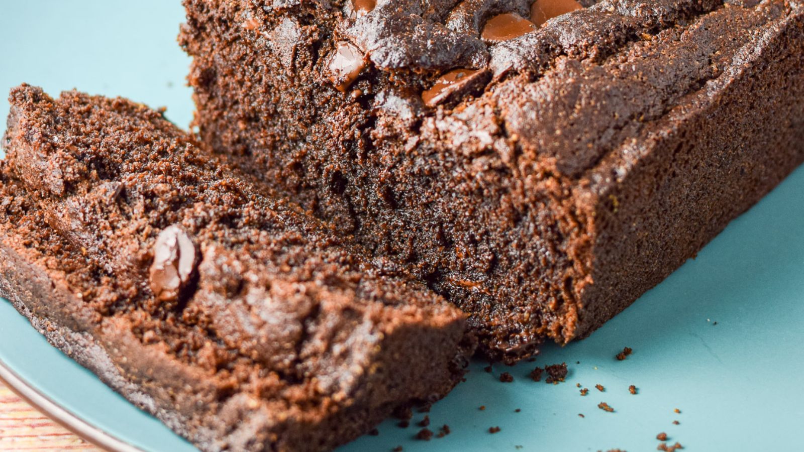 a double chocolate bread on a blue plate with two slices