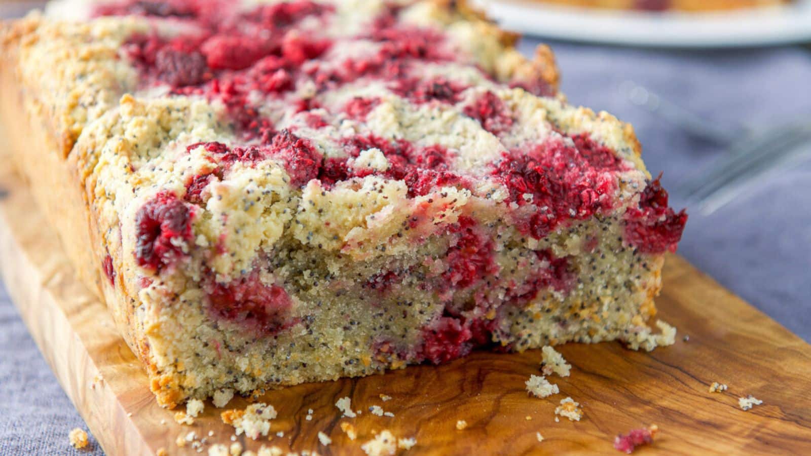 lemon poppyseed raspberry bread on a wooden board