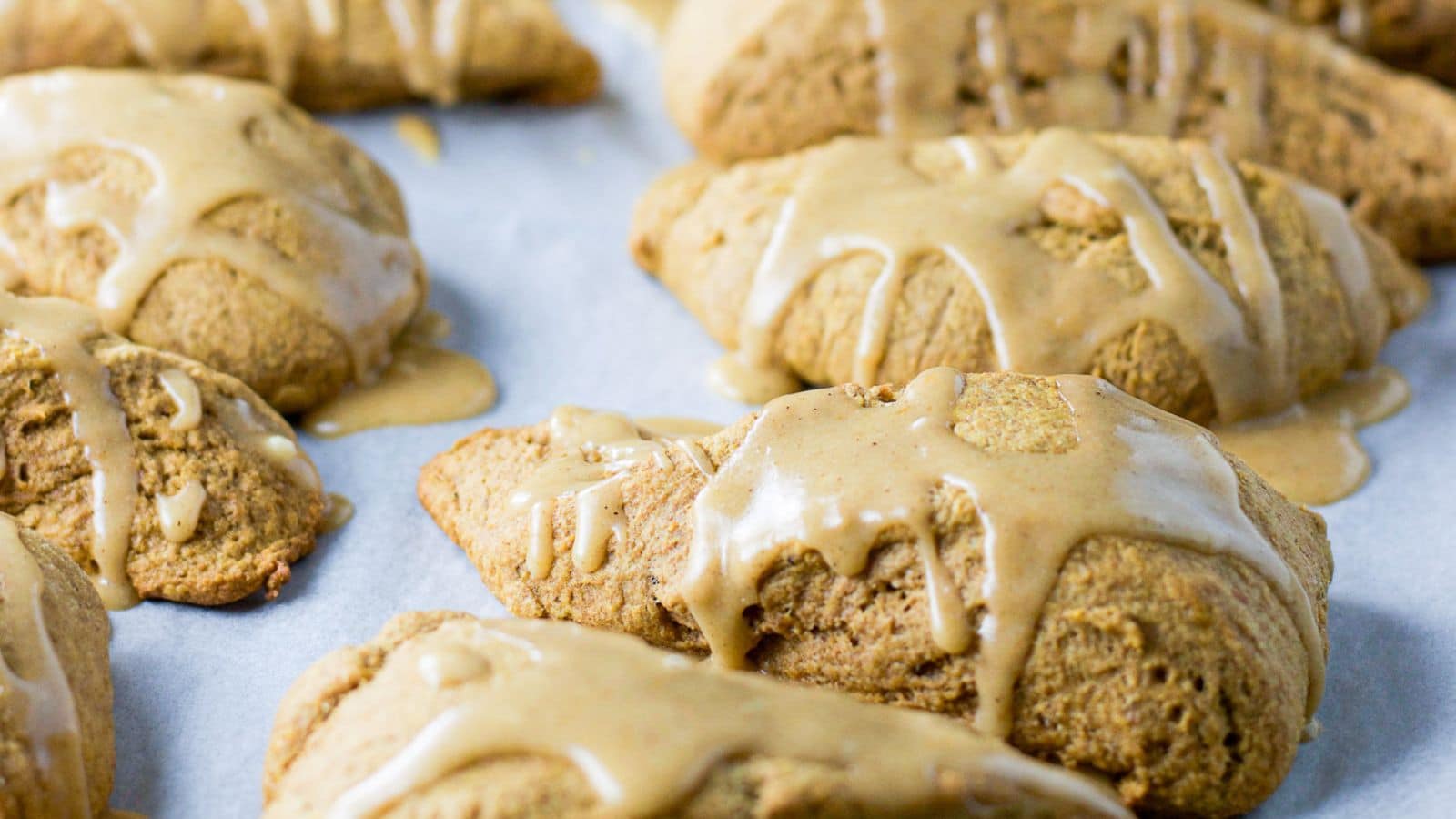 Scones on a pan with maple glaze on it