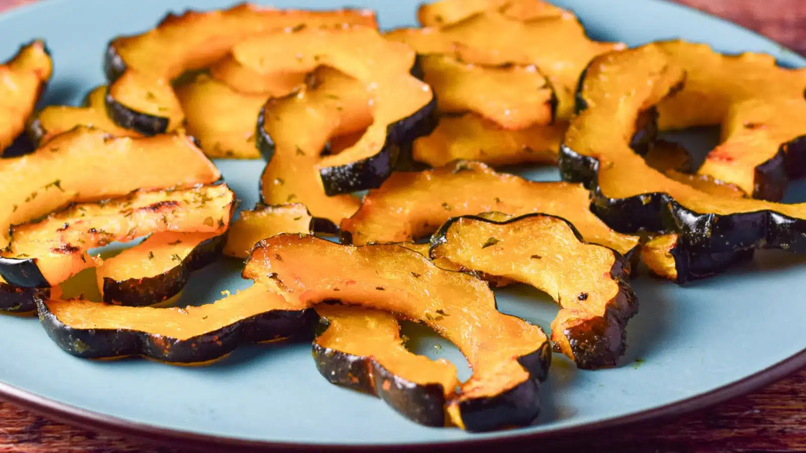 a blue plate with sliced acorn squash that was roasted