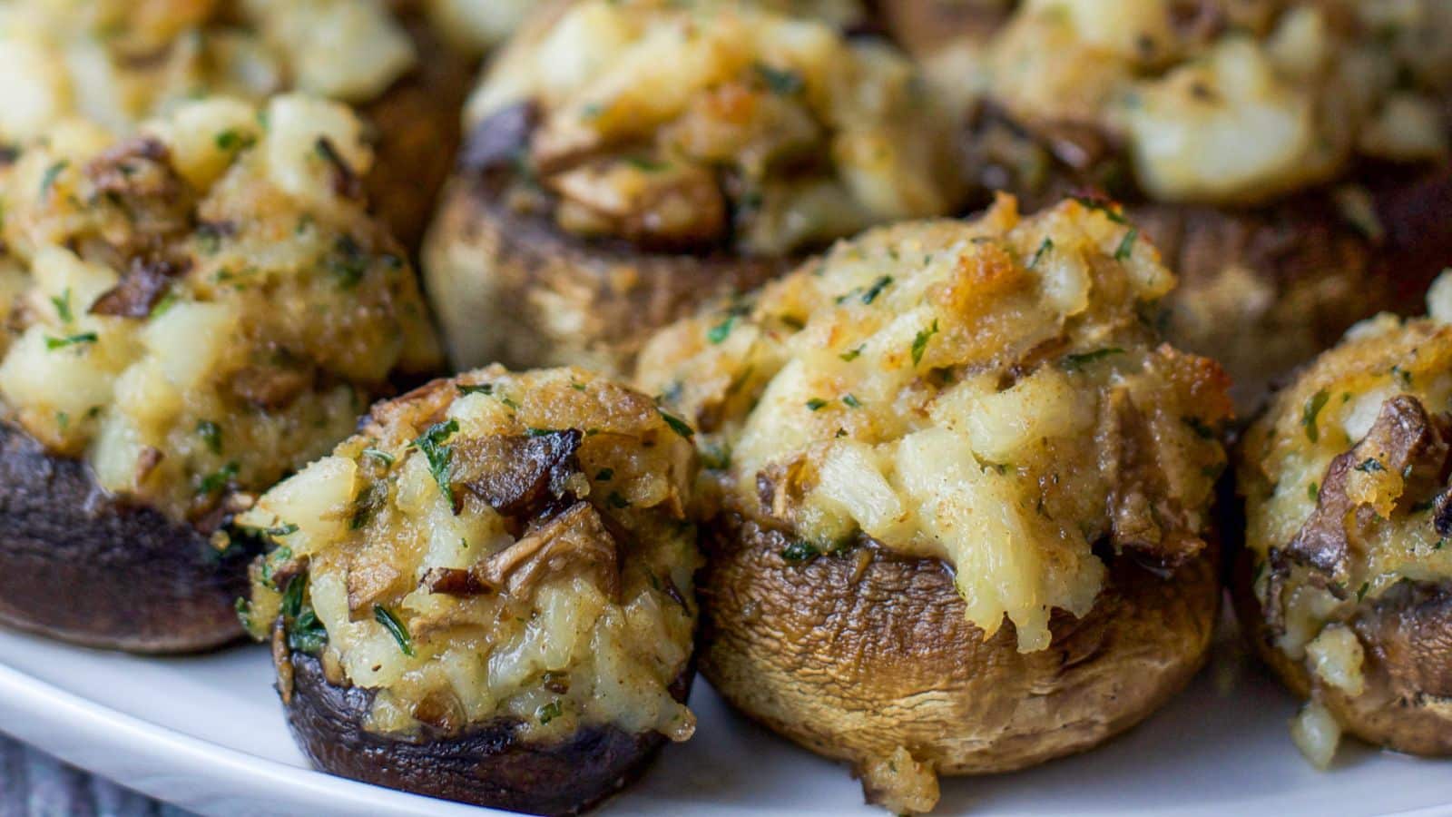 Stuffed mushrooms piled on a white plate
