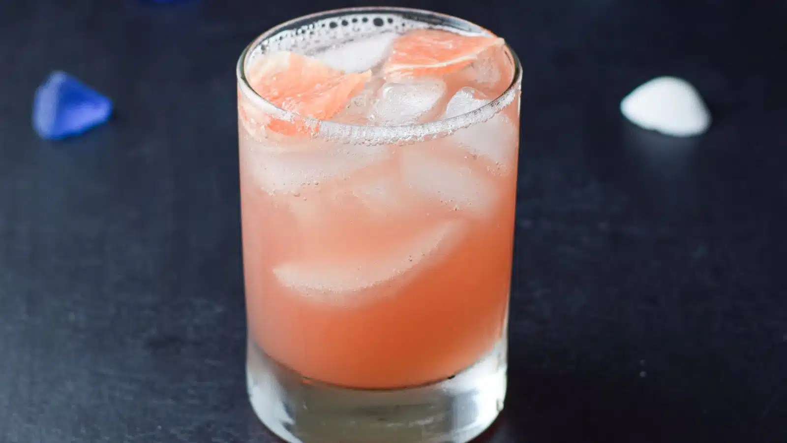 a double old fashioned glass filled with the grapefruit drink