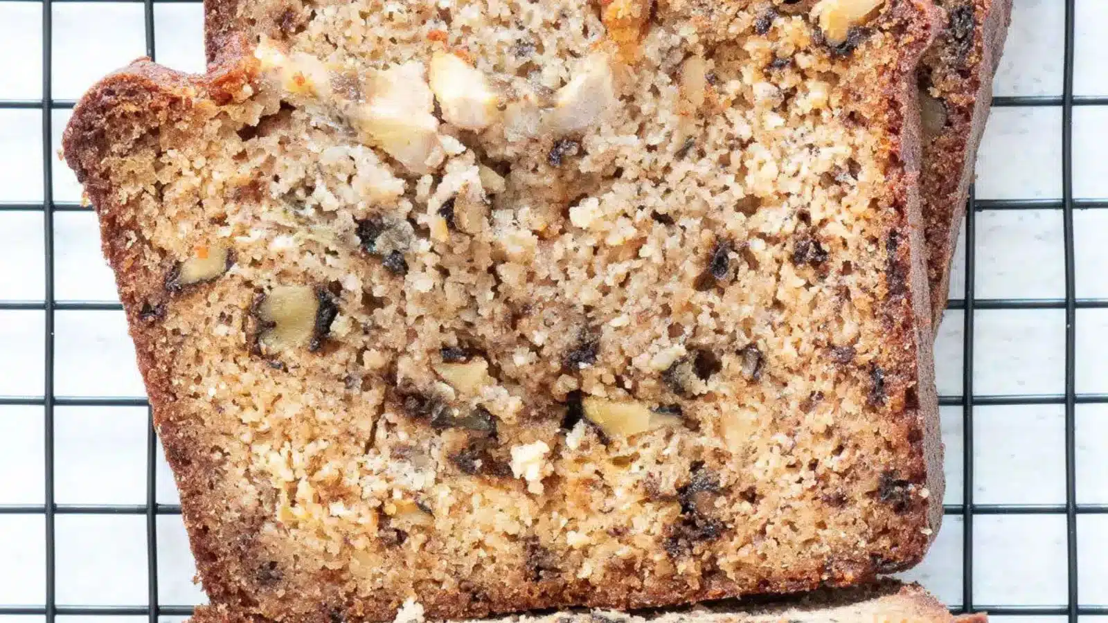 overhead view of a slice of banana bread with walnuts