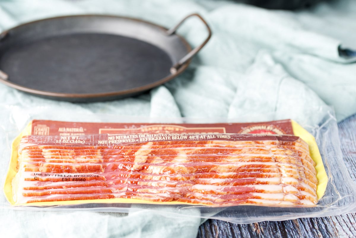 A package of bacon with a tray behind it
