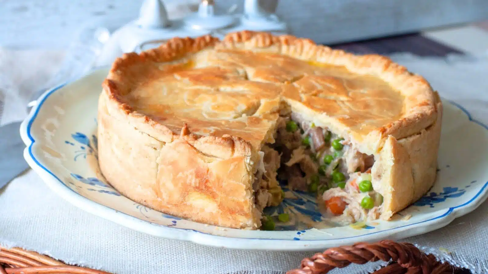 A plate with a double crusted chicken pot pie with mushrooms