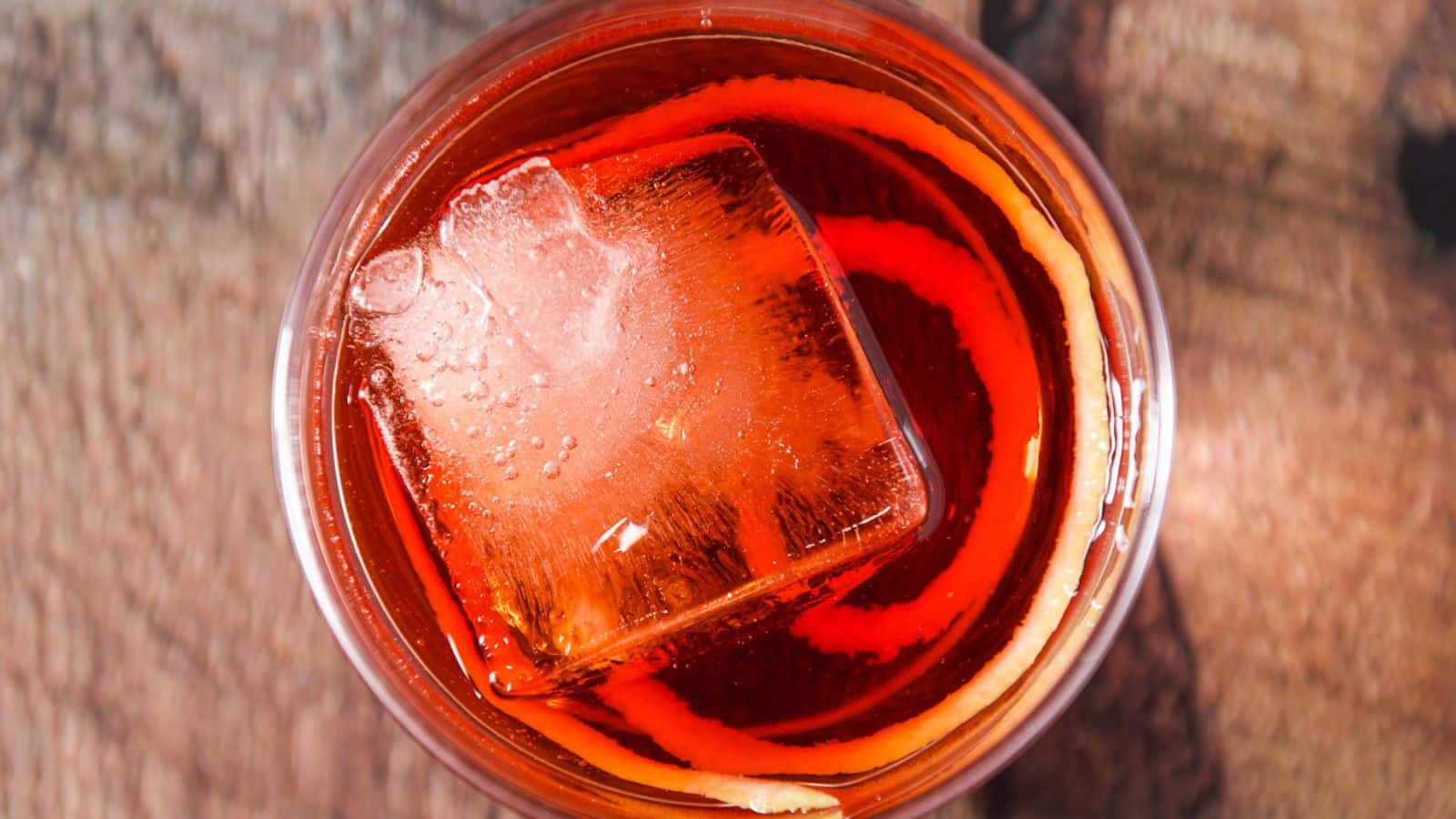 overhead view of the negroni with an ice cube and lemon twist