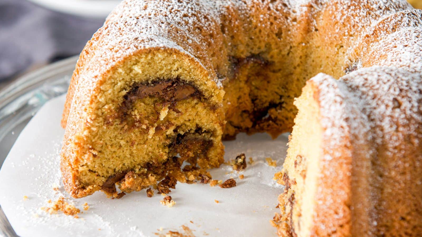 a bundt cake filled with nutella with powdered sugar on top - there are pieces cut out