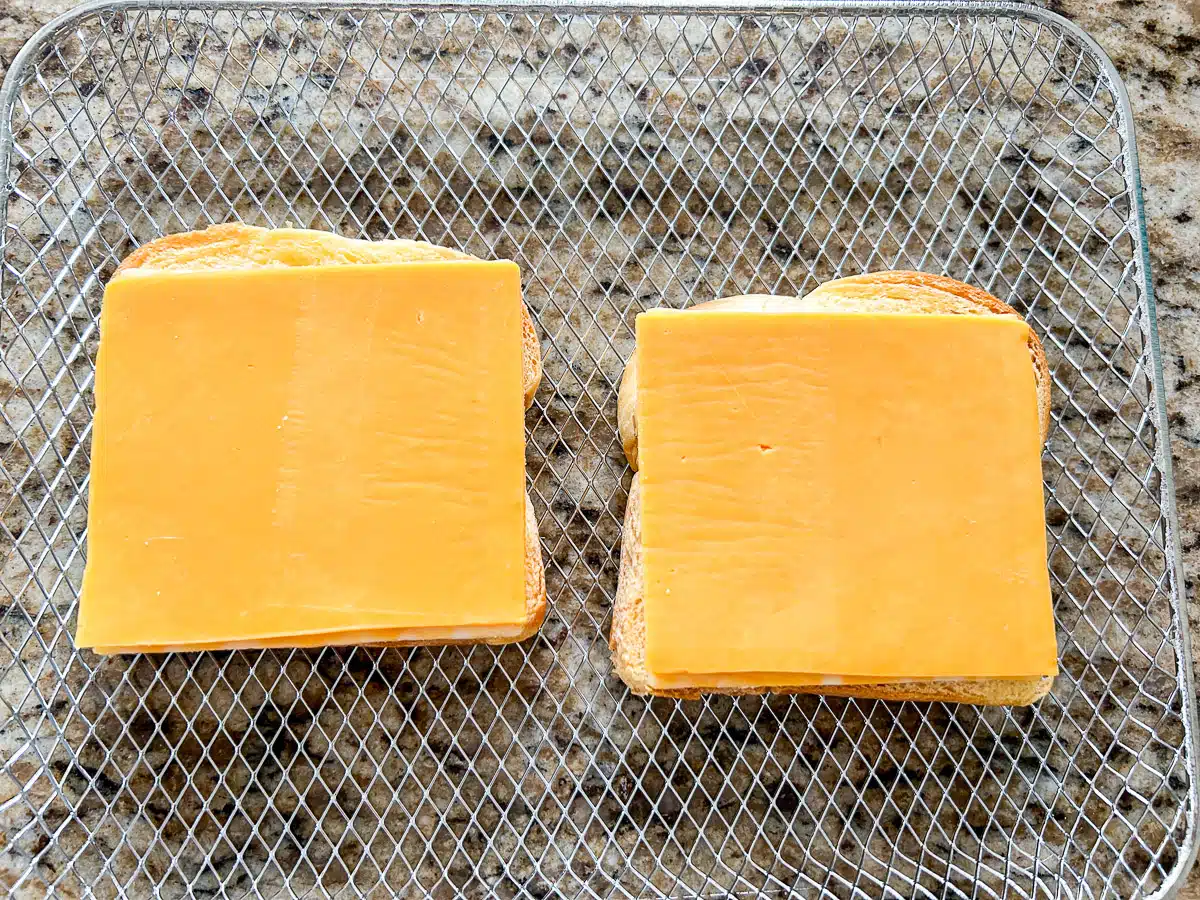 a wire rack with cheddar cheese on bread