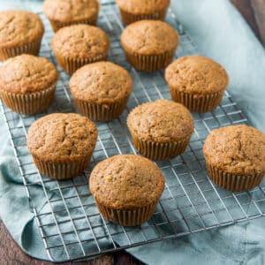 square photo of a wire rack with cooling muffins on it