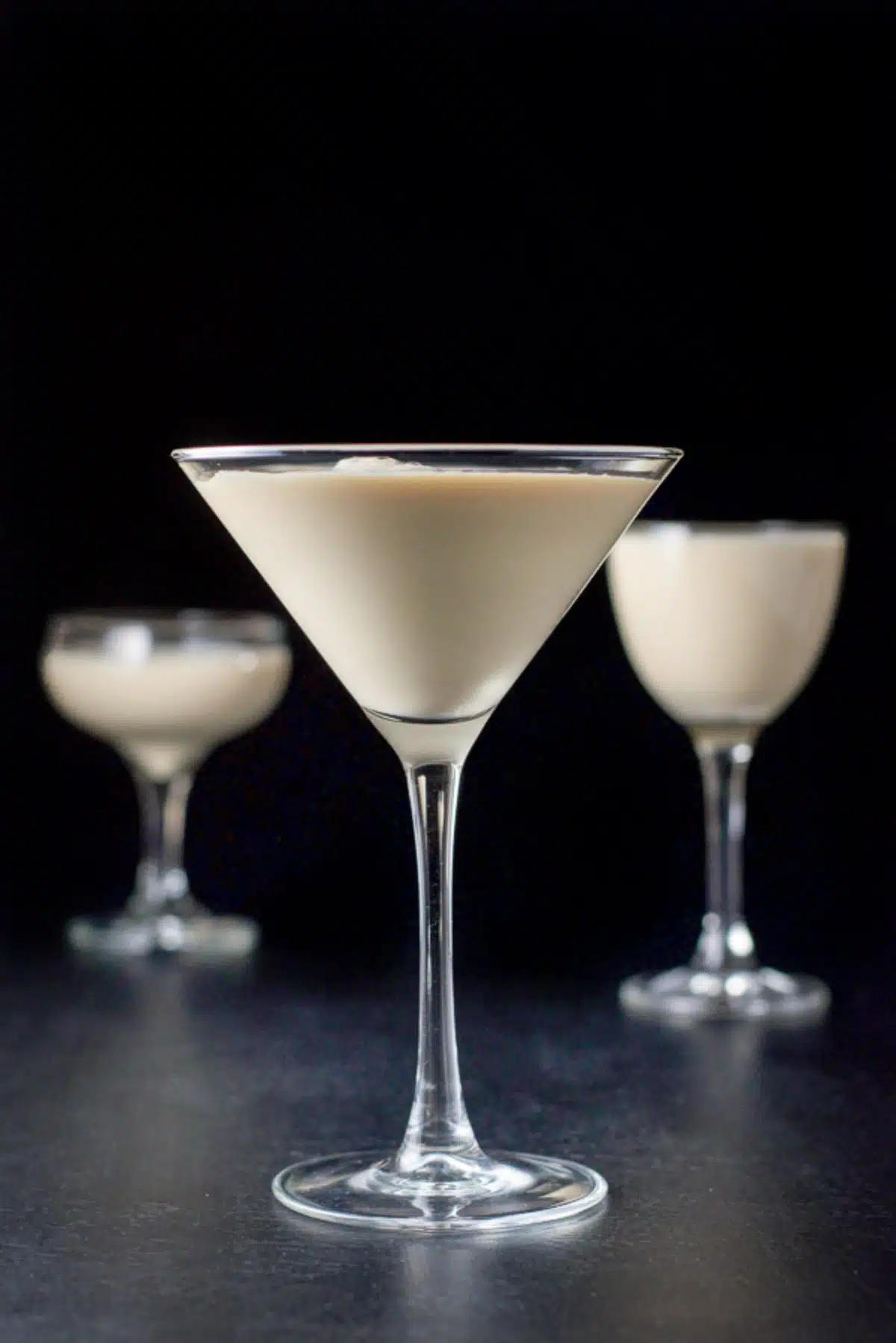 Vertical view of the creamy cocktail in the martini glasses and coupes