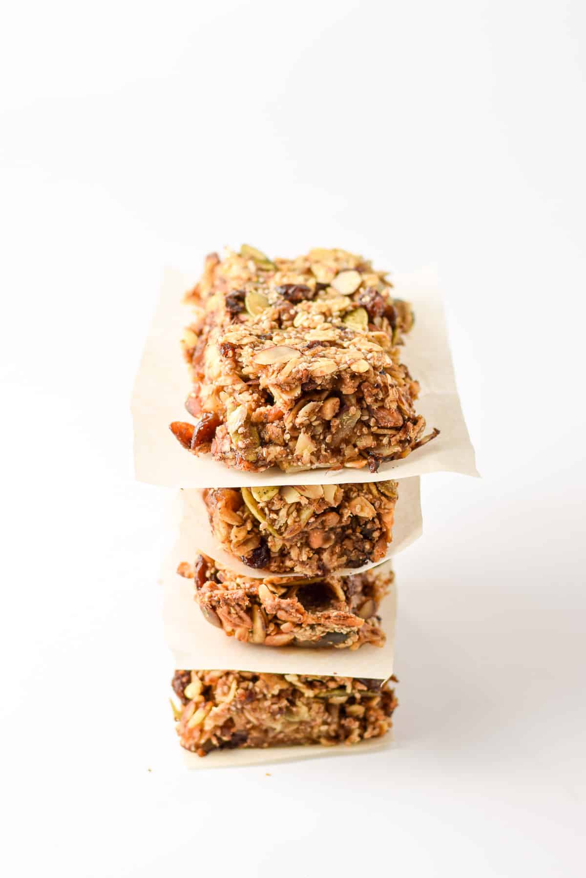 Four bars cut up and stacked with parchment paper between them. They are on a white background