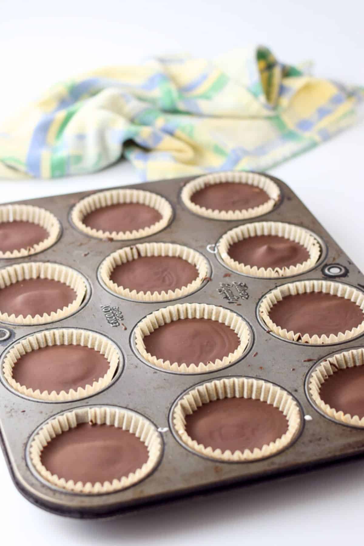 chocolate hardened in a muffin pan in paper liners