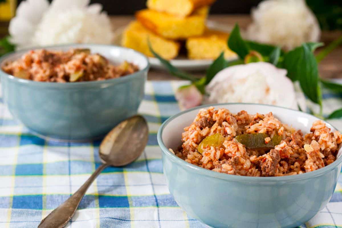 Two bowls of spanish rice with ground beef.