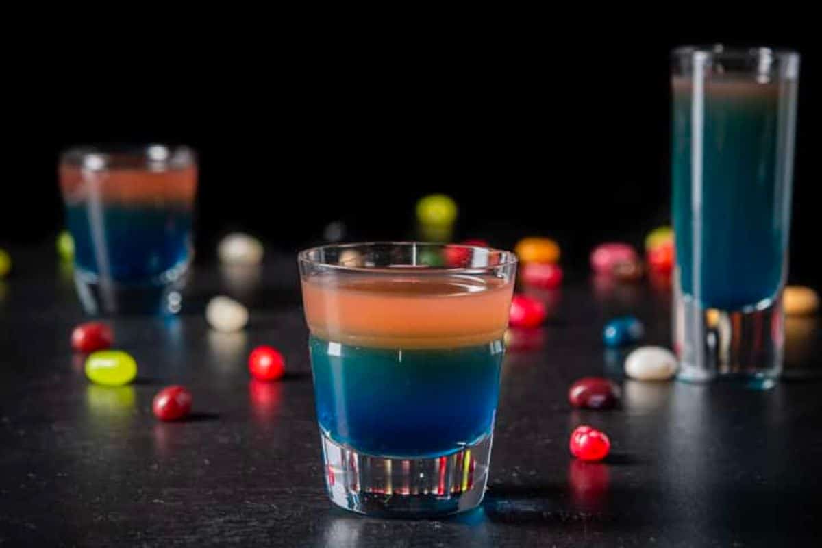 Square of the vertical view of the beveled glass in front of the two other glasses ad jelly beans on the table