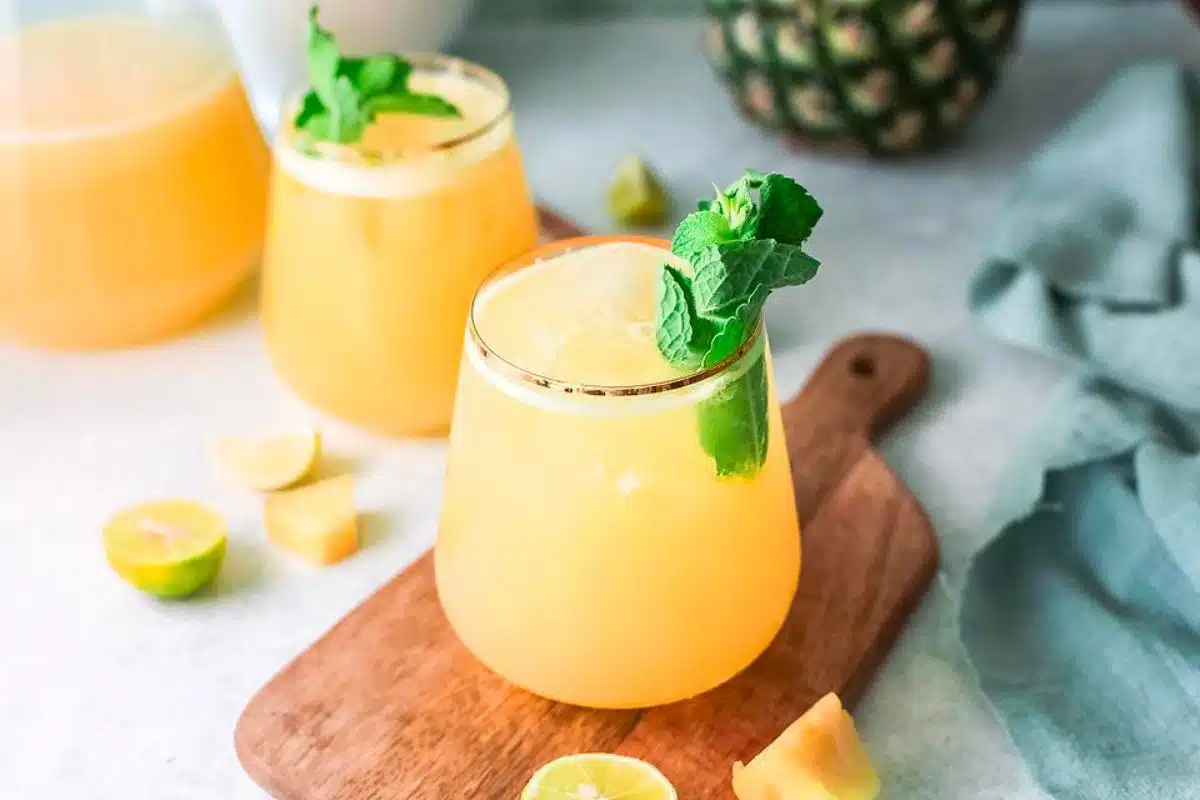 Two glasses of pineapple agua fresca.