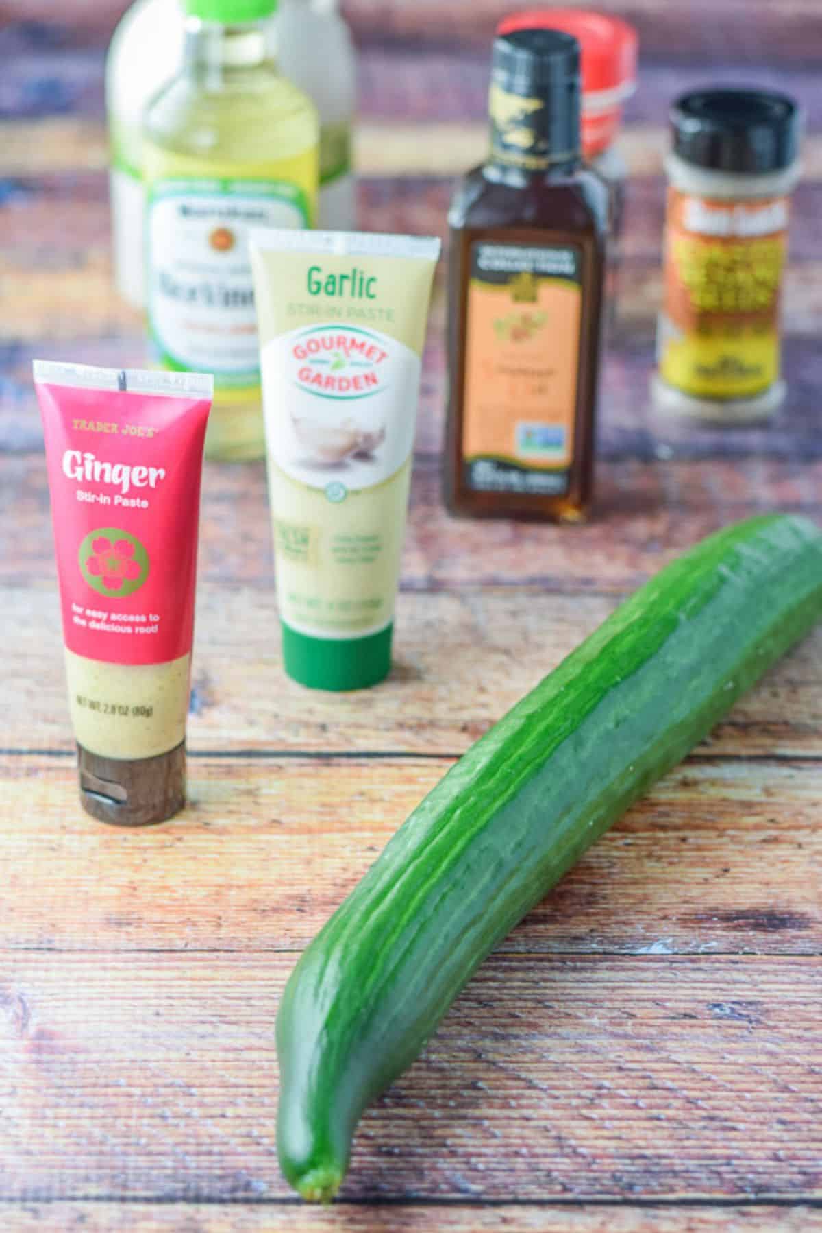 Cucumber, ginger, garlic, sesame oil, rice vinegar, sesame seeds, and maple syrup on the table