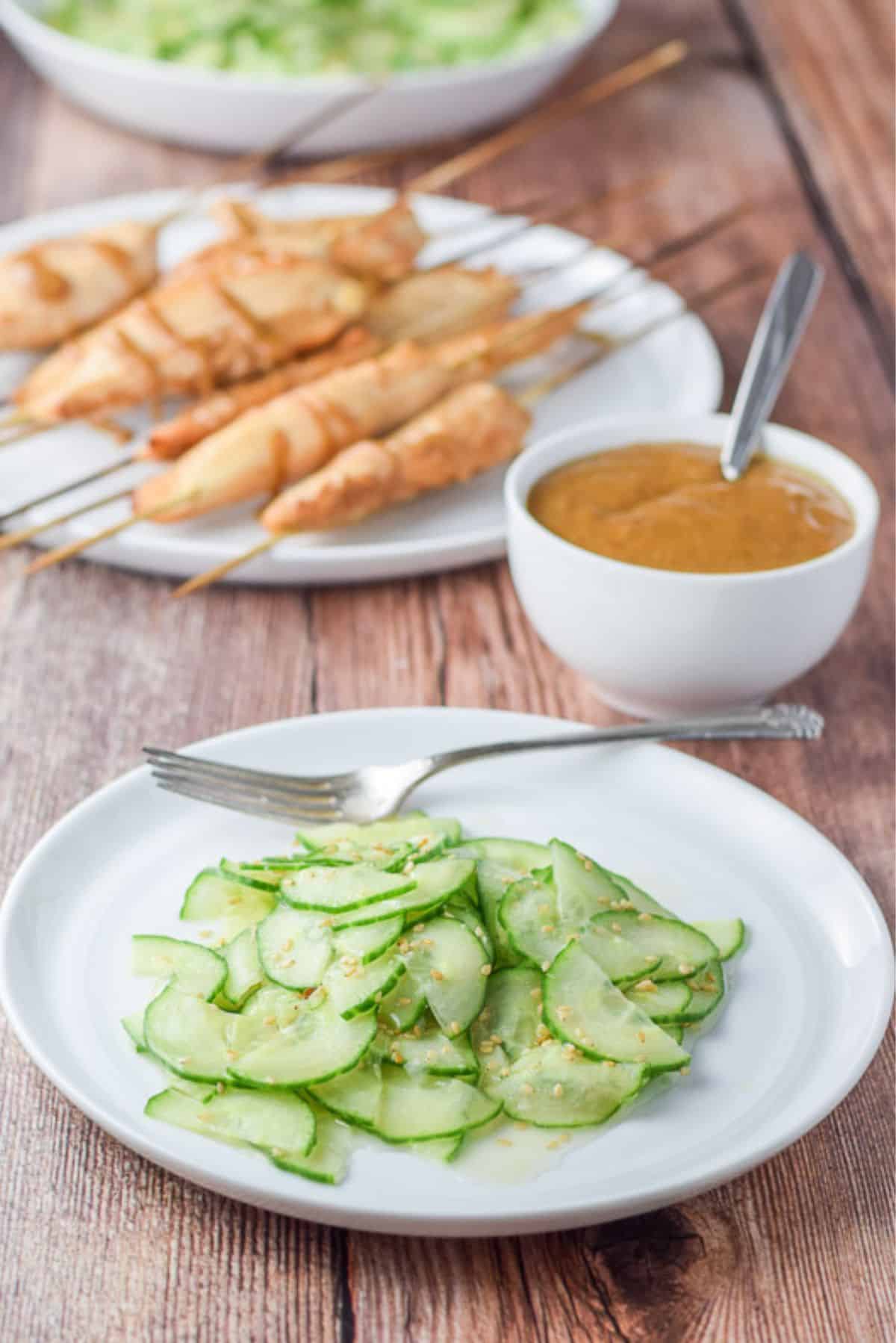 The cucumber with dressing served with chicken satay and peanut sauce