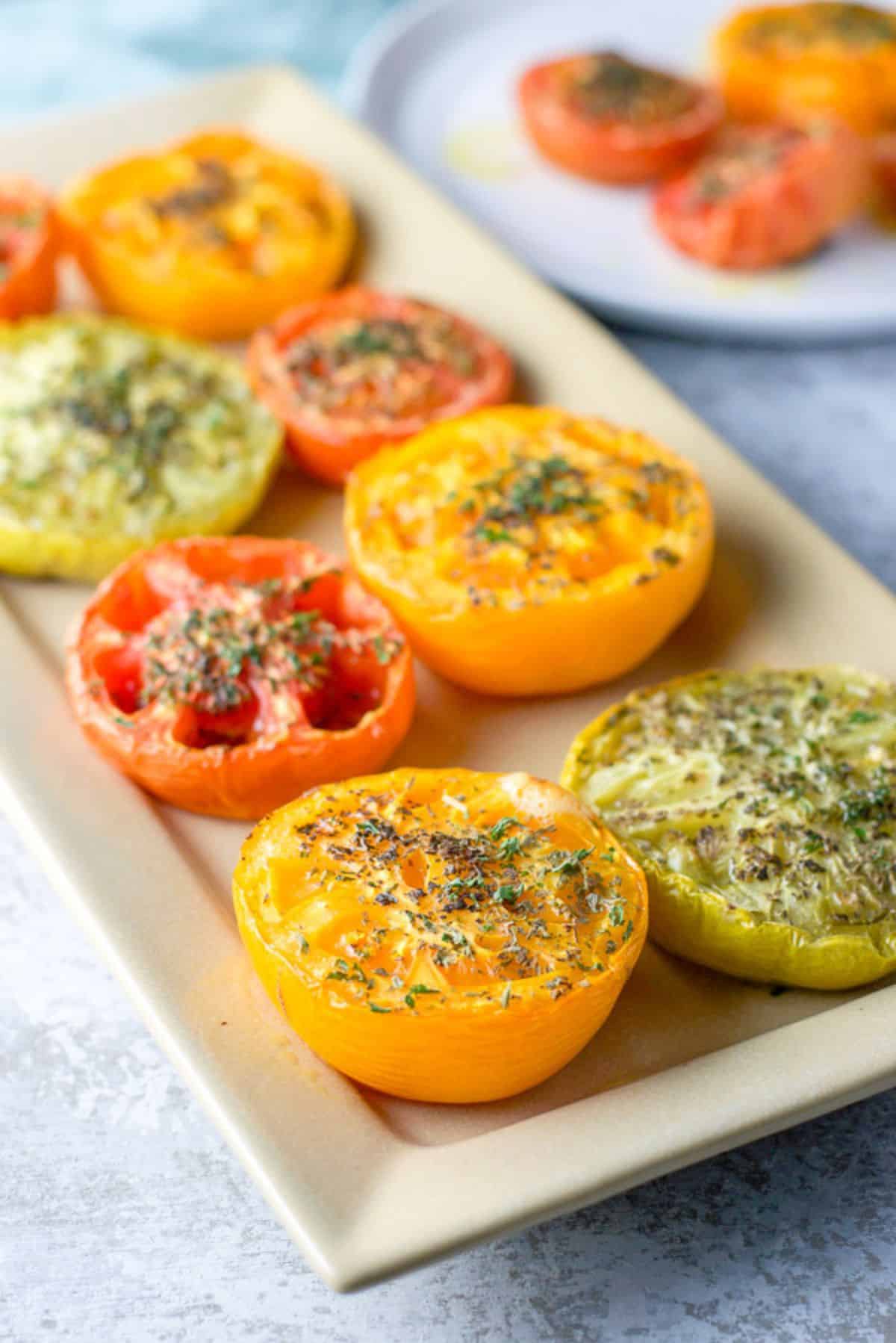 Close up of the tomatoes on a rectangle platter with another plate in the background