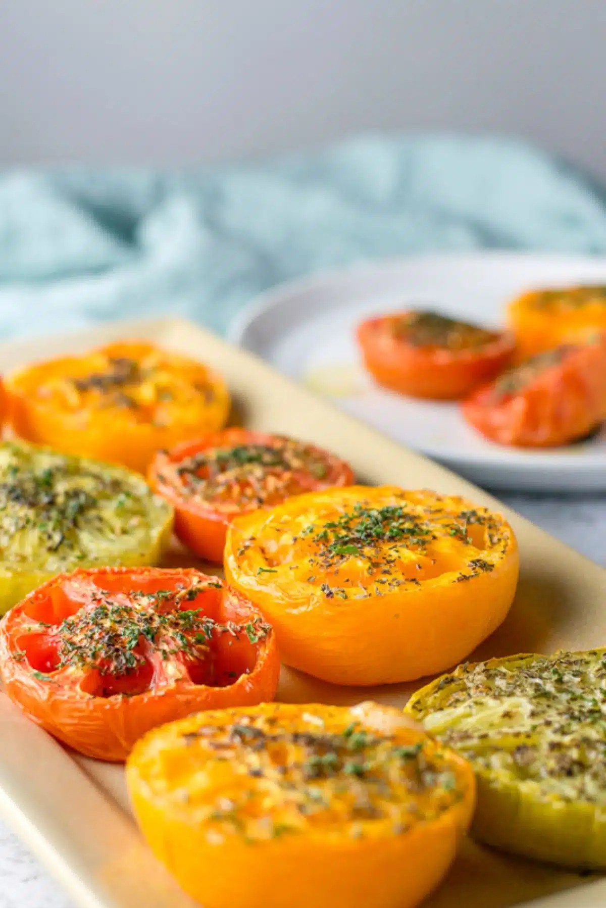 Tomato halves with oil and herbs on it