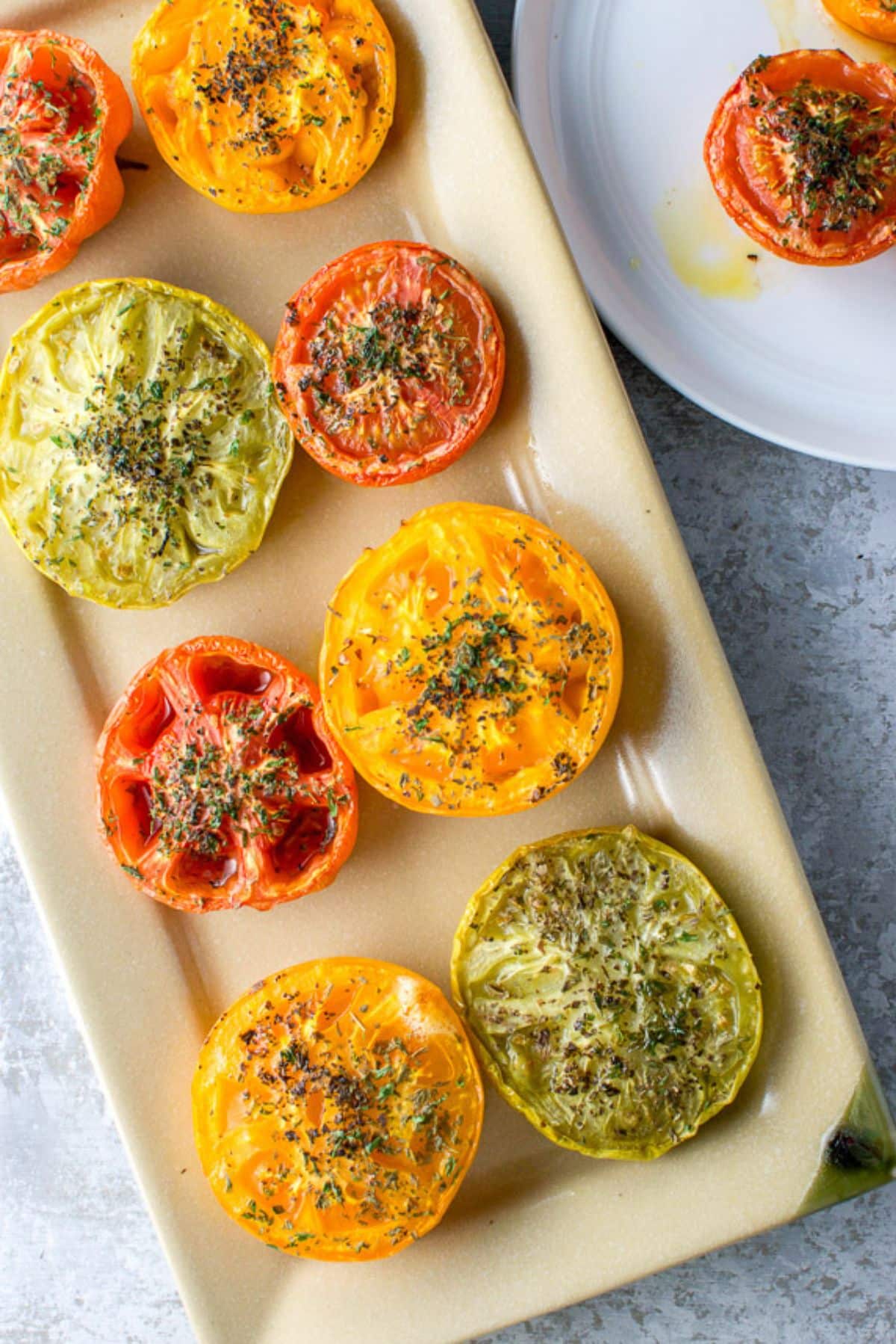 Overhead view of the rectangle platter with tomatoes with herbs on it