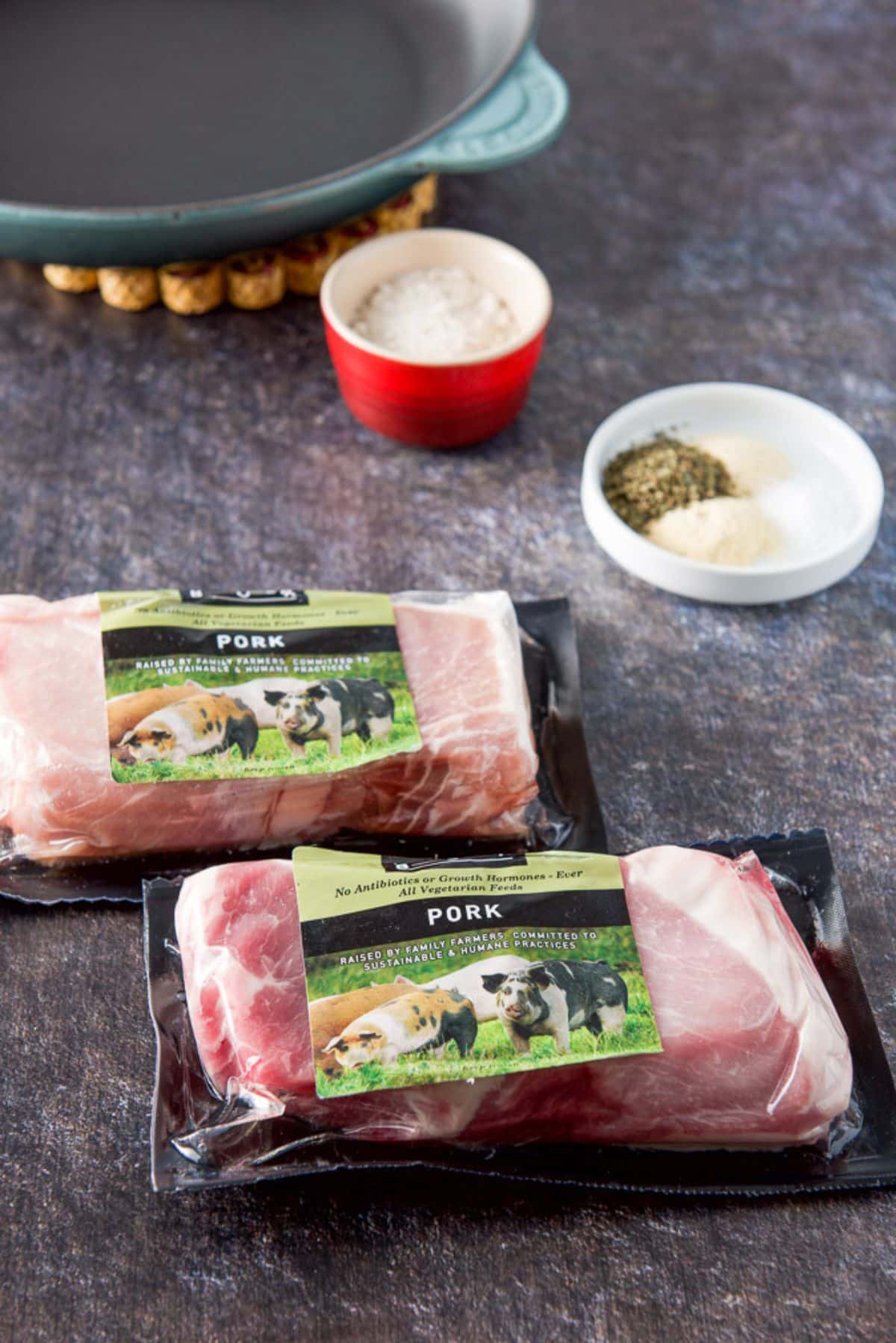 Pork chops in two packages with herbs, flour and spices ready to be mixed to bread them