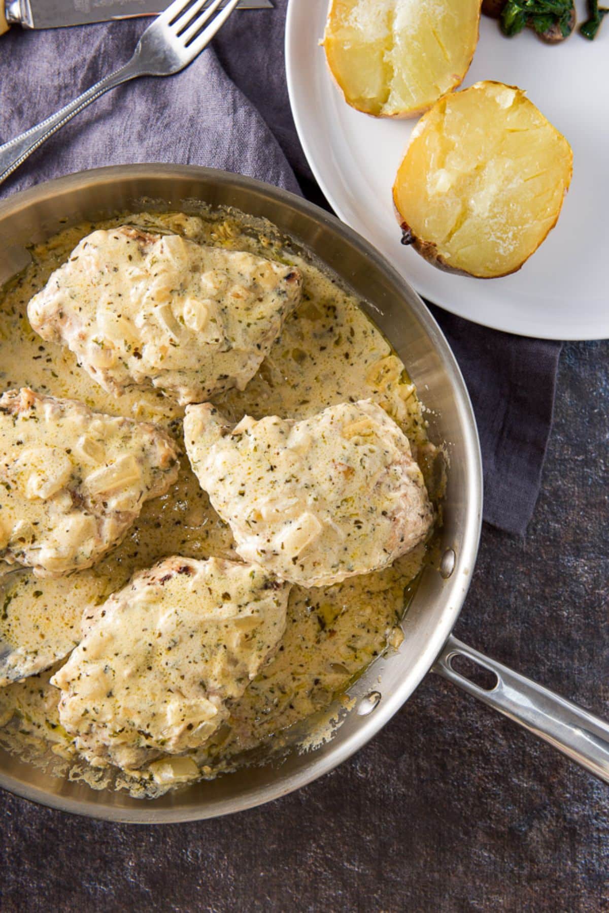Overhead view of the pork chops with cream sauce on top