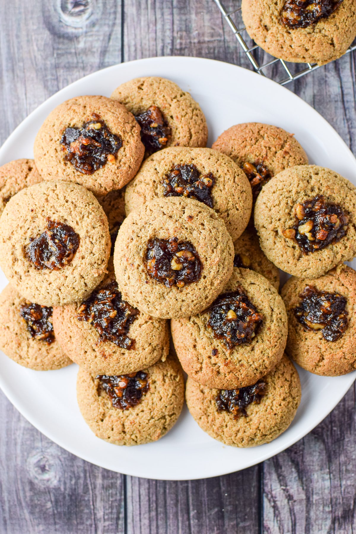 Overhead view of thumbprint cookies on a white plate