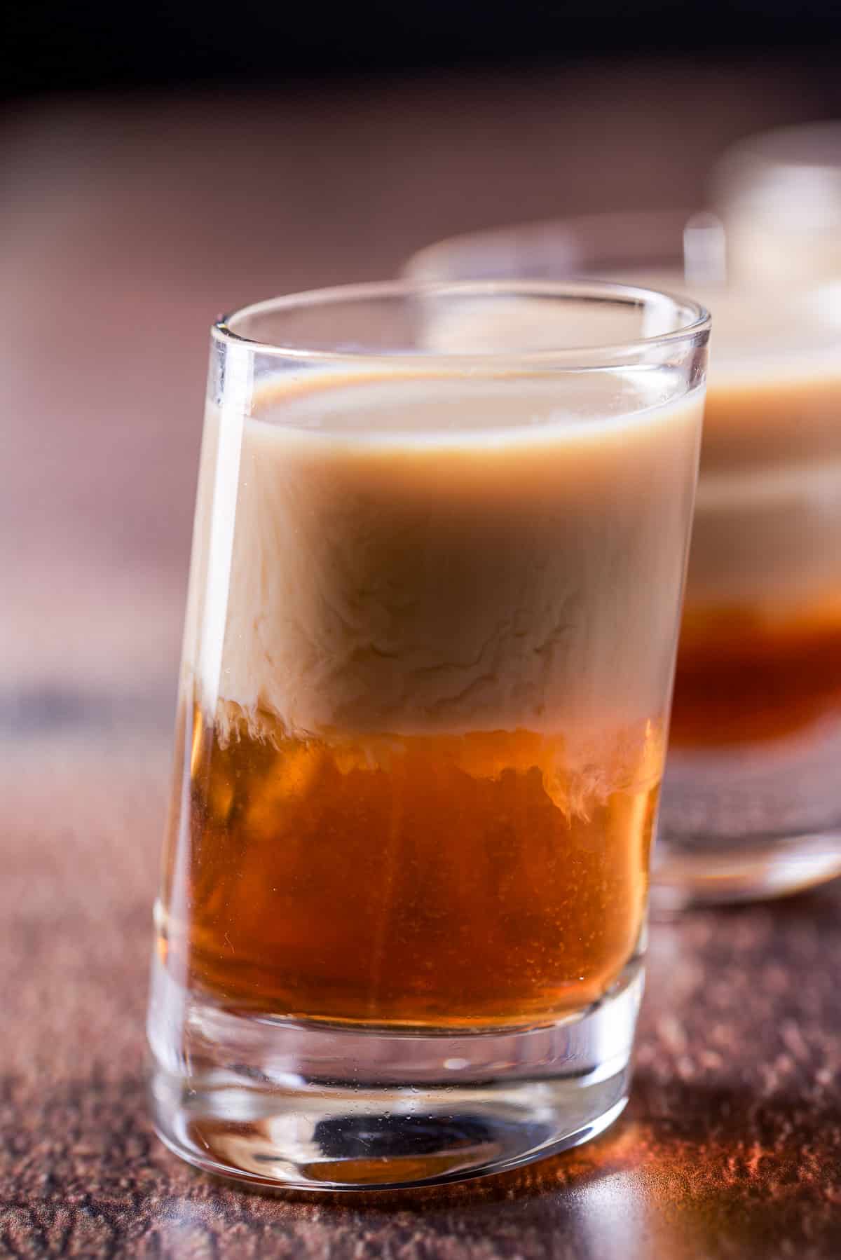 Close view of the layered drink in the shot glass