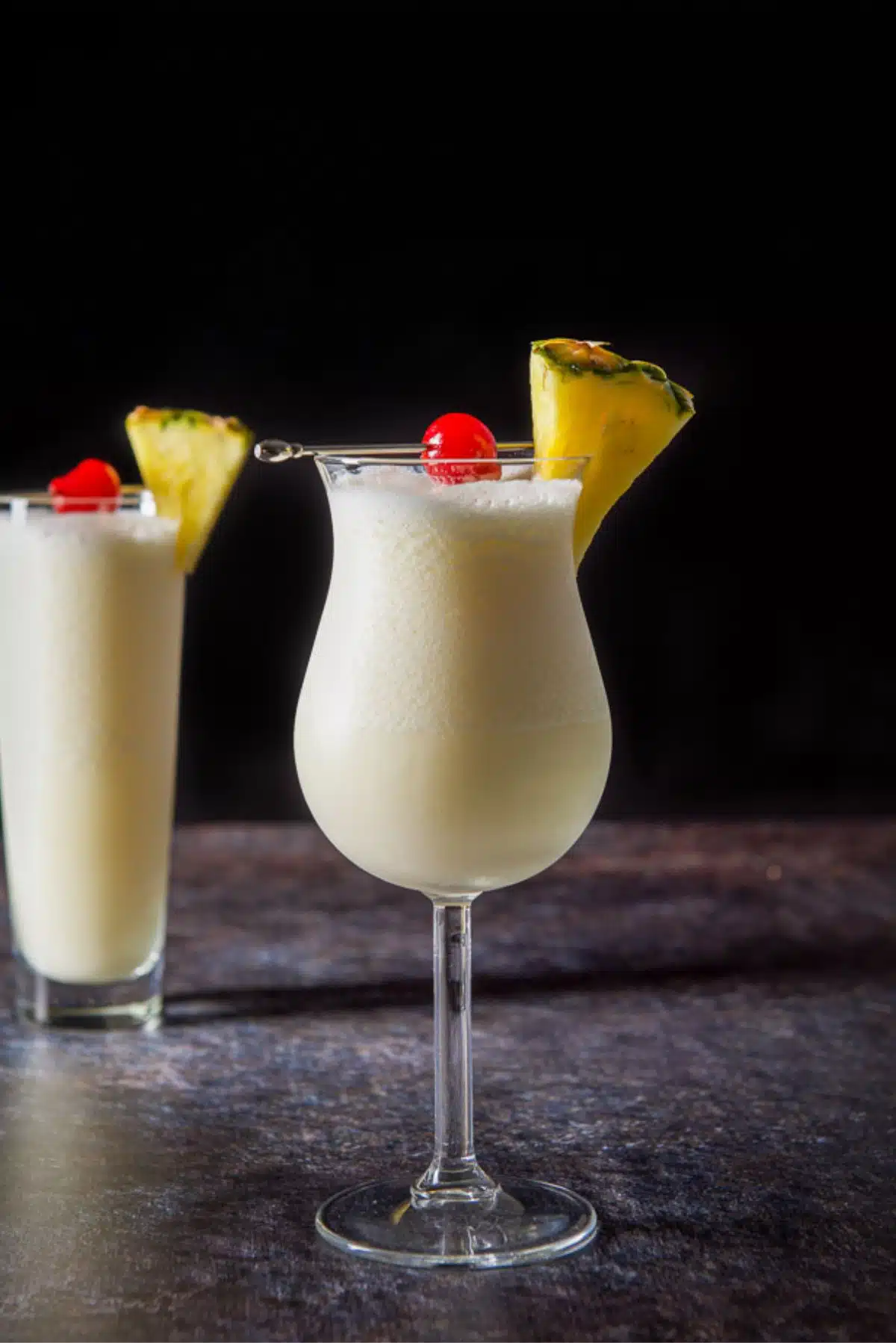 vertical view of the pina colada cocktail in two glasses