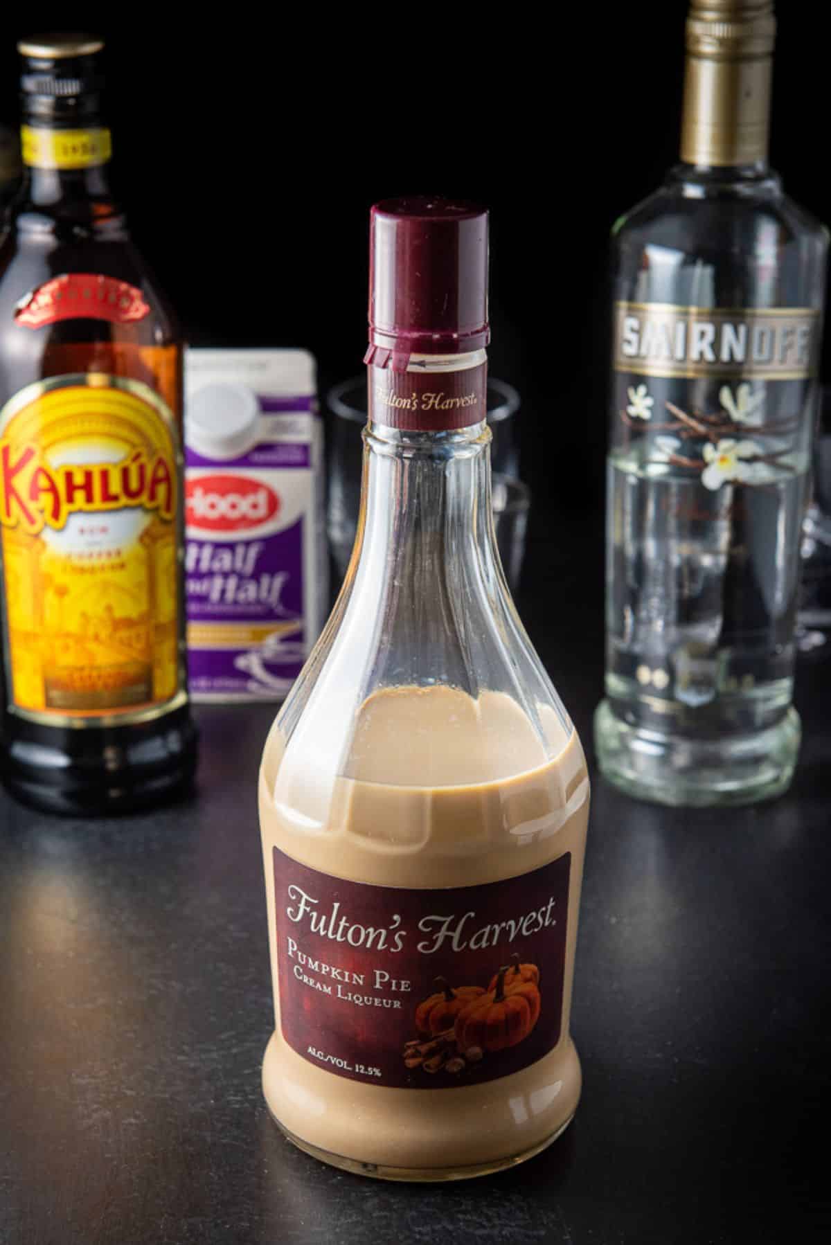 Pumpkin spice liquor, Kahlua, vanilla vodka and cream on a table