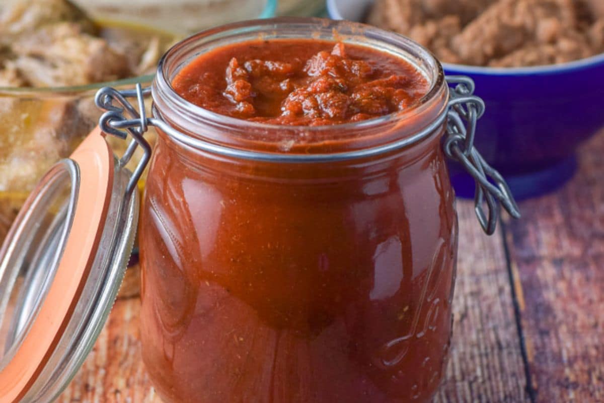A jar full of enchilada sauce.