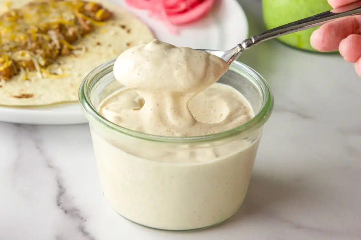 Spoonful of Mexican crema over the jar