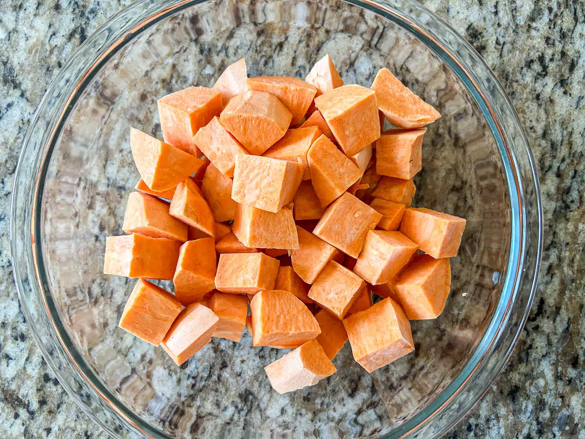 A glass bowl with big cubes of sweet potato