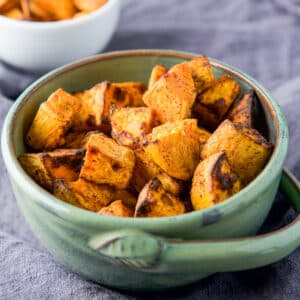 square photo of a green bowl filled with the potatoes