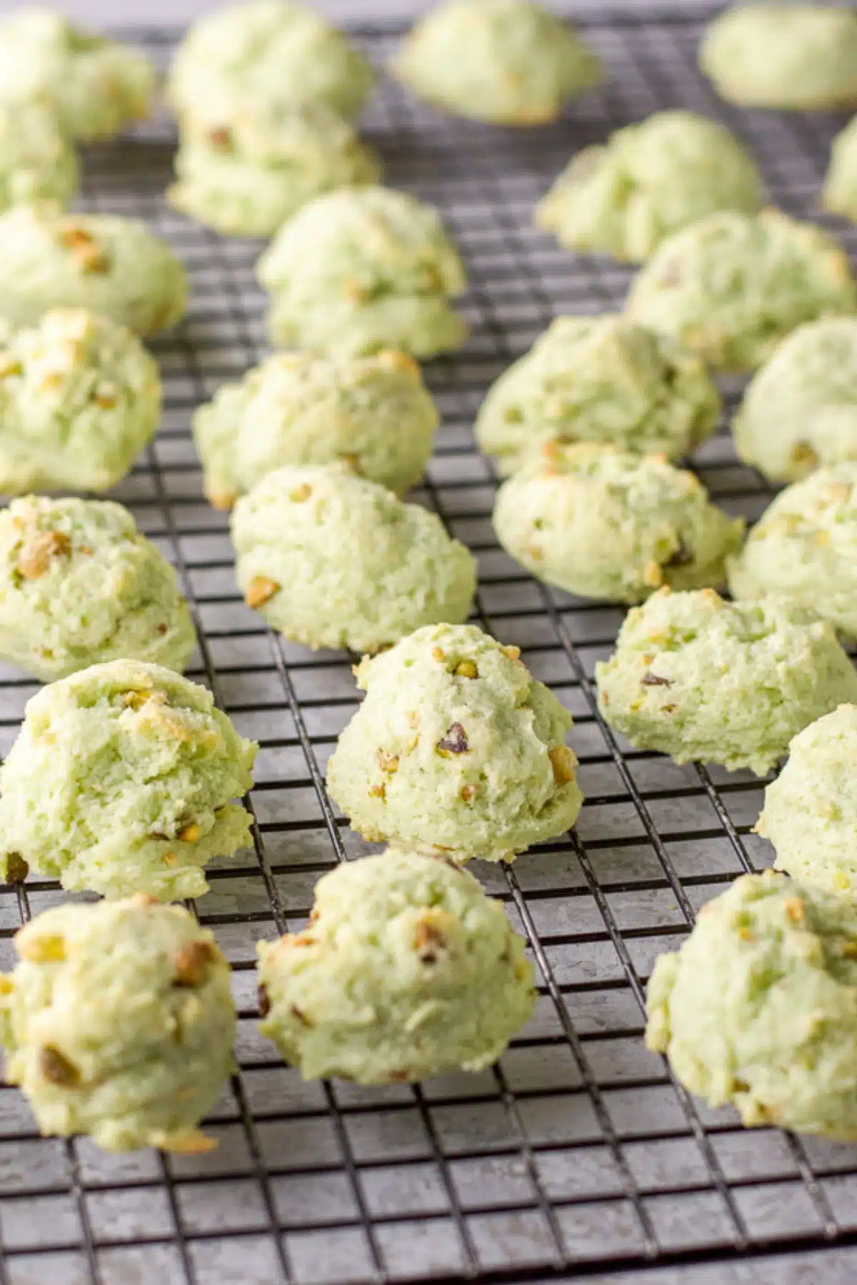 Green nut cookies cooling on a wire rack