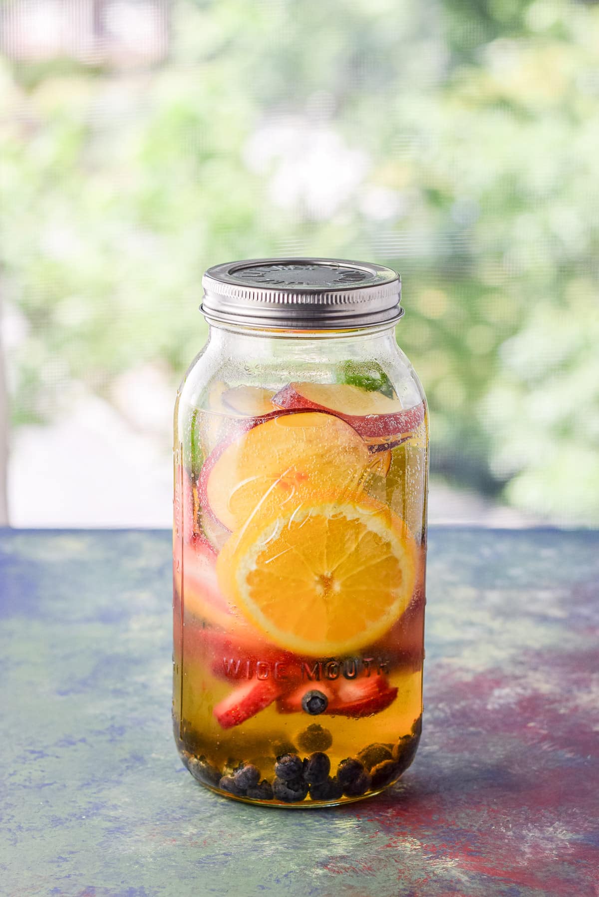 Lid on the jar full of the white sangria